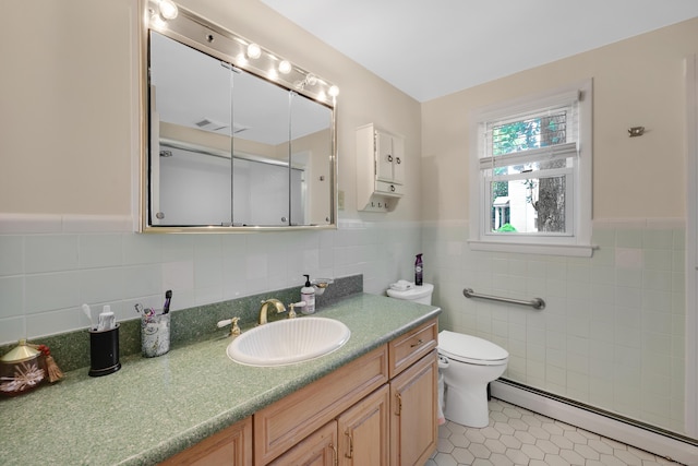 full bathroom with baseboard heating, tile walls, a wainscoted wall, tile patterned floors, and toilet