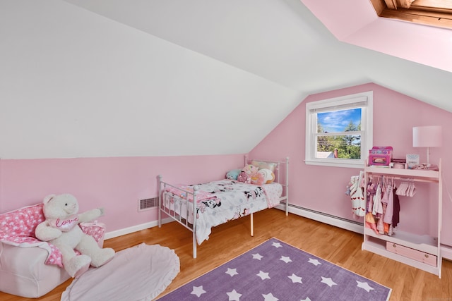 bedroom with a baseboard radiator, wood finished floors, lofted ceiling, and baseboards