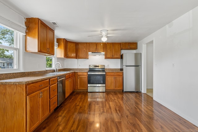 31 Scott St, East Hartford, CT 06118 - kitchen with appliances with stainless steel finishes, under cabinet range hood, a sink, dark wood-type flooring, and a ceiling fan