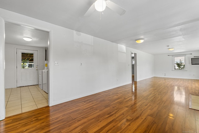 31 Scott St, East Hartford, CT 06118 - unfurnished living room featuring wood finished floors, a ceiling fan, washer and dryer, and baseboards