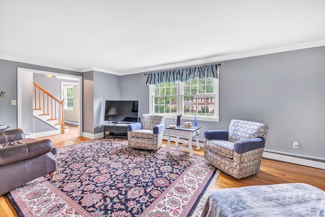 living room featuring a baseboard heating unit, crown molding, stairway, and wood finished floors