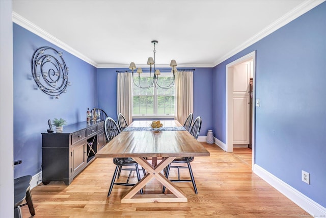 dining space with baseboards, light wood-style flooring, ornamental molding, and a chandelier