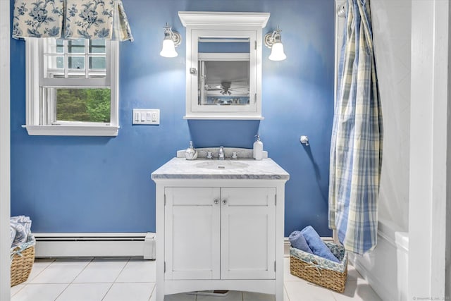 bathroom with a baseboard heating unit, vanity, and tile patterned flooring
