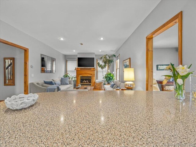 571 Pond Point Ave, Milford, CT 06460 - kitchen with a fireplace, recessed lighting, and light stone countertops