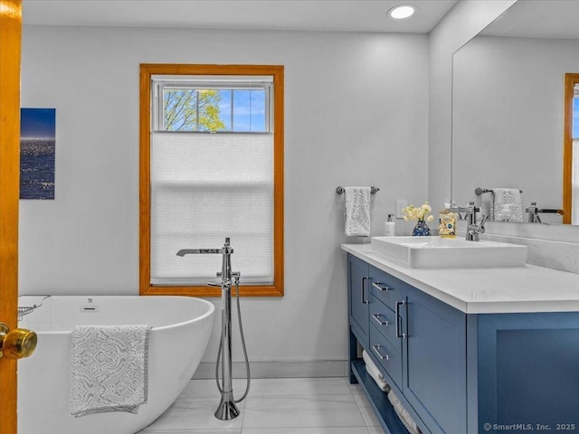 571 Pond Point Ave, Milford, CT 06460 - full bath featuring vanity, a soaking tub, and baseboards