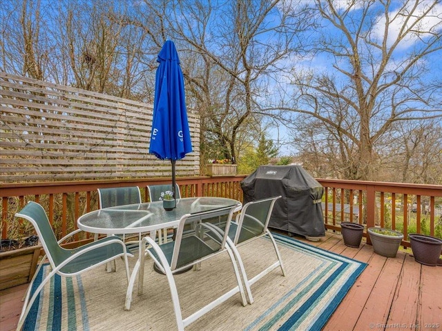 571 Pond Point Ave, Milford, CT 06460 - wooden terrace with a grill and outdoor dining area