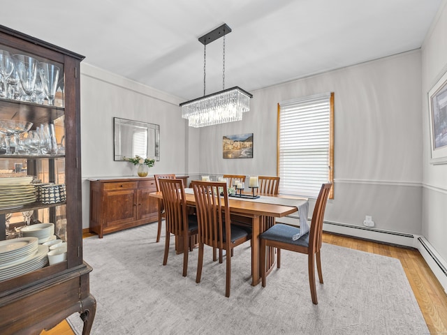 571 Pond Point Ave, Milford, CT 06460 - dining space featuring a chandelier, light wood finished floors, and a baseboard radiator