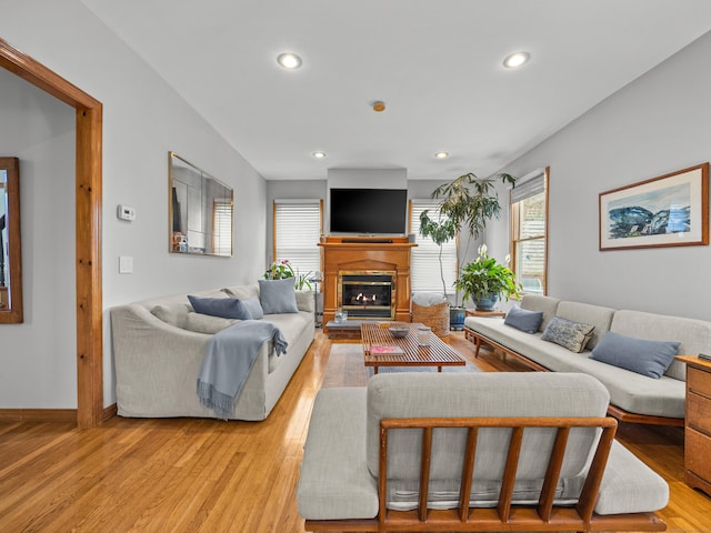 571 Pond Point Ave, Milford, CT 06460 - living area featuring recessed lighting, a glass covered fireplace, light wood-style floors, and baseboards