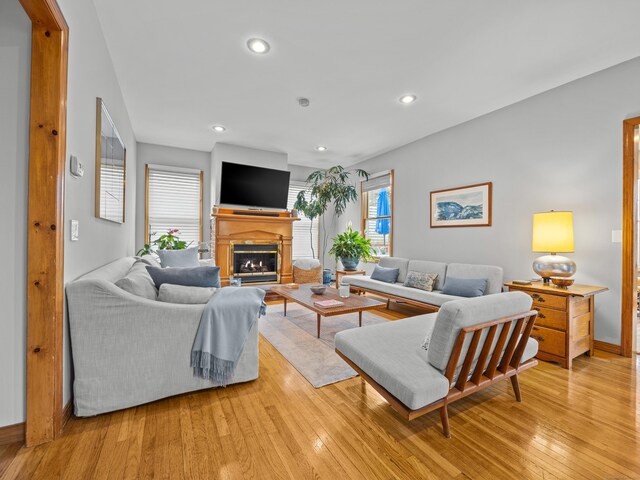 571 Pond Point Ave, Milford, CT 06460 - living room with a glass covered fireplace, light wood-type flooring, recessed lighting, and baseboards