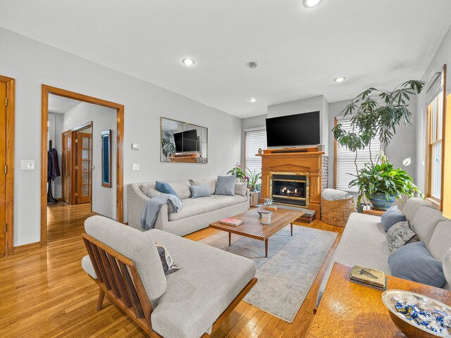 571 Pond Point Ave, Milford, CT 06460 - living room featuring recessed lighting, light wood-style floors, and a glass covered fireplace