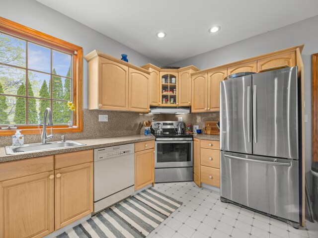 571 Pond Point Ave, Milford, CT 06460 - kitchen featuring appliances with stainless steel finishes, a sink, under cabinet range hood, light brown cabinets, and light flooring
