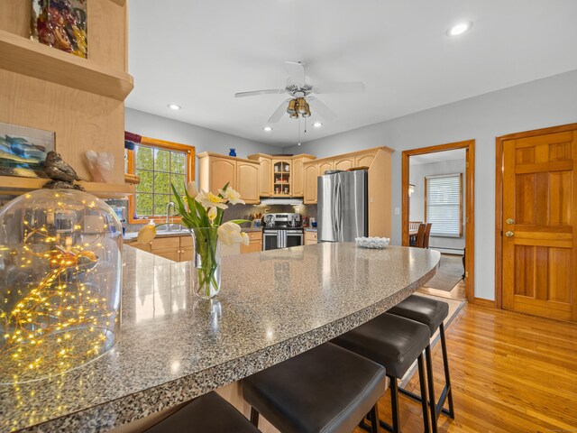 571 Pond Point Ave, Milford, CT 06460 - kitchen with stainless steel appliances, a peninsula, a ceiling fan, a breakfast bar, and recessed lighting