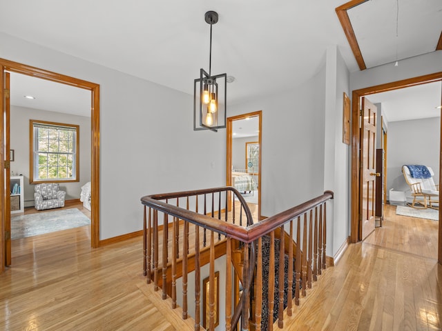 571 Pond Point Ave, Milford, CT 06460 - hall featuring an upstairs landing, attic access, light wood finished floors, and baseboards