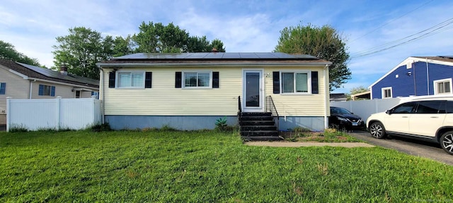 view of front of property featuring entry steps and roof mounted solar panels