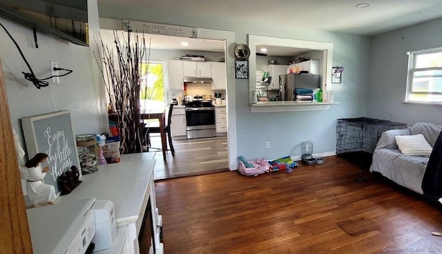 living area with wood finished floors and baseboards
