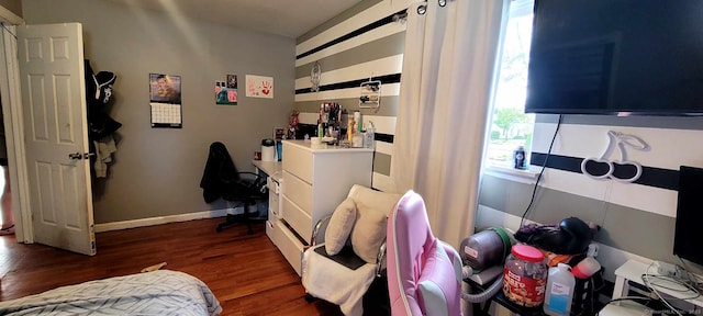 bedroom featuring dark wood finished floors, multiple windows, and baseboards