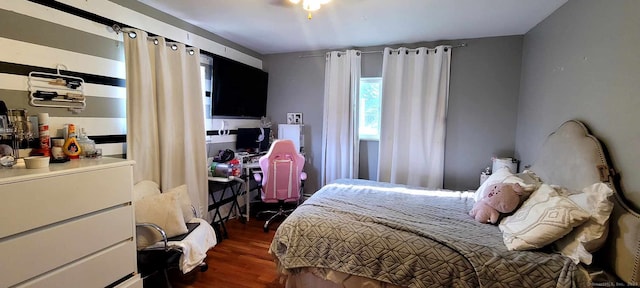 bedroom with dark wood-style flooring