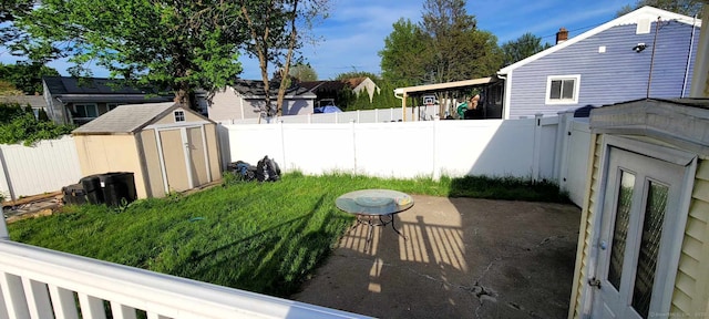 fenced backyard with a shed, an outdoor structure, and a patio