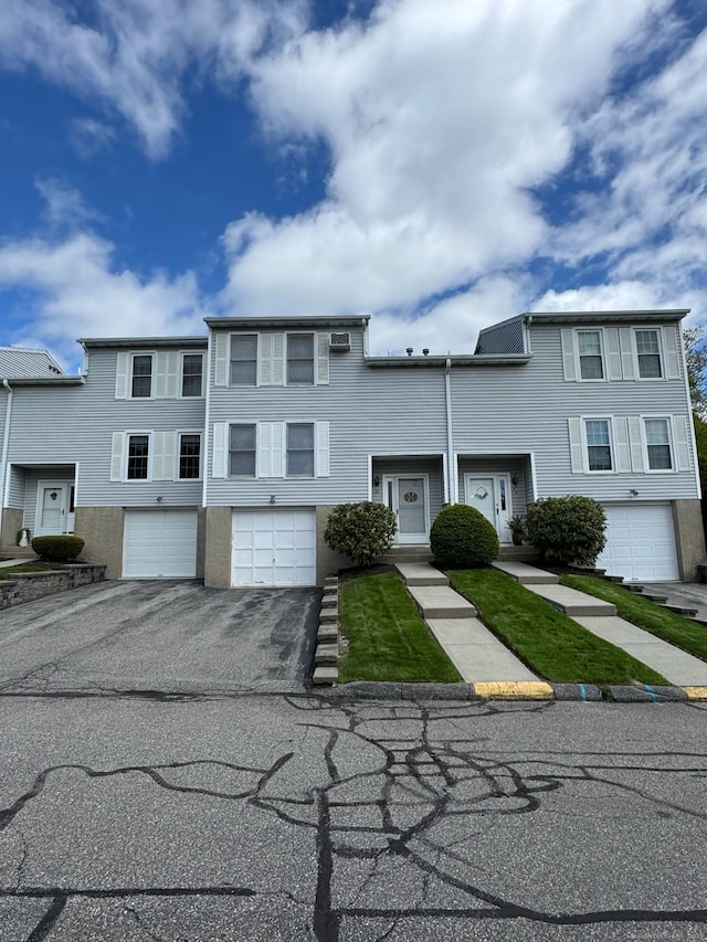 multi unit property with a garage and driveway