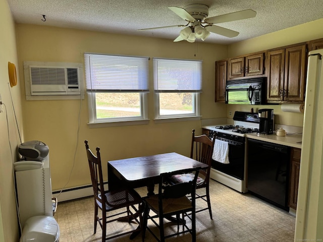 kitchen with black appliances, light floors, a ceiling fan, a wall mounted AC, and a baseboard heating unit