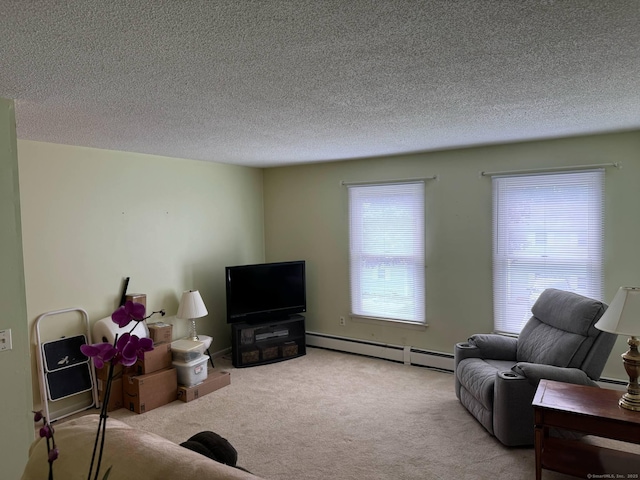 carpeted living area with a baseboard heating unit and a textured ceiling