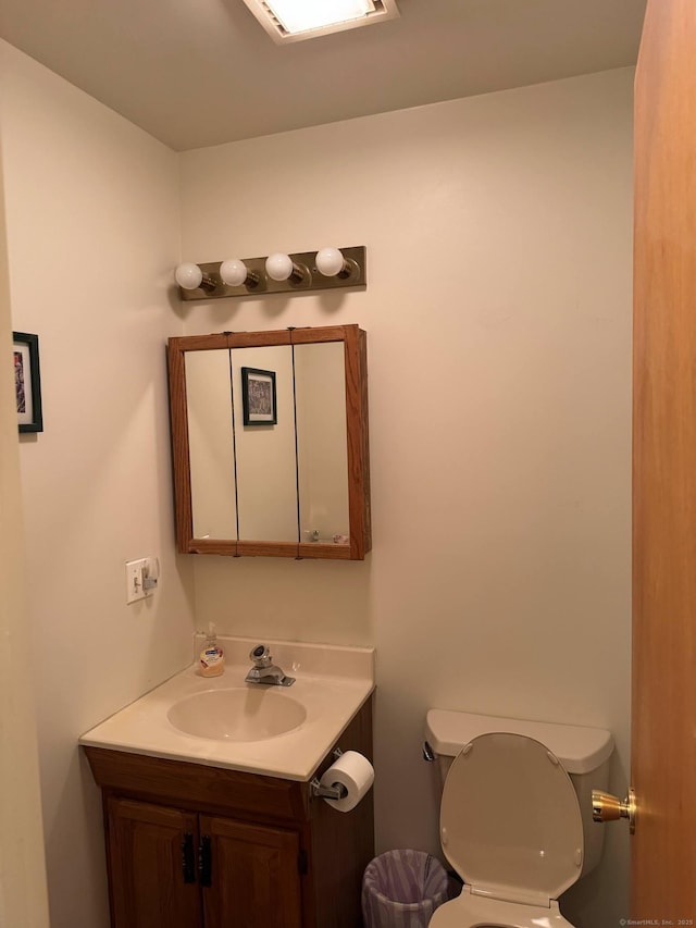 bathroom featuring toilet and vanity