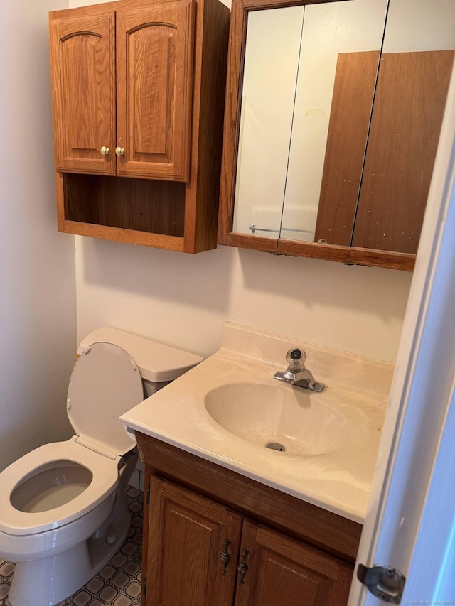 bathroom featuring vanity and toilet