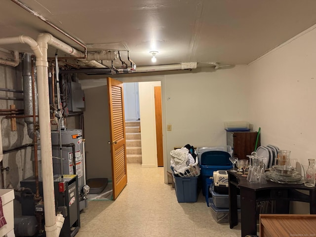 finished basement featuring tile patterned floors, stairway, and electric panel