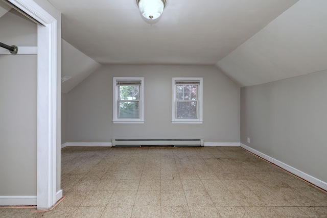 bonus room with baseboard heating, lofted ceiling, baseboards, and tile patterned floors