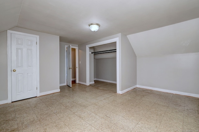 additional living space featuring vaulted ceiling, baseboards, and tile patterned floors