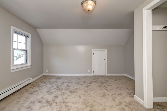 bonus room with a baseboard radiator, vaulted ceiling, baseboards, and carpet floors