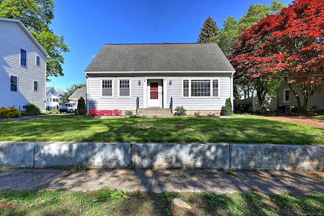 cape cod house featuring a front lawn
