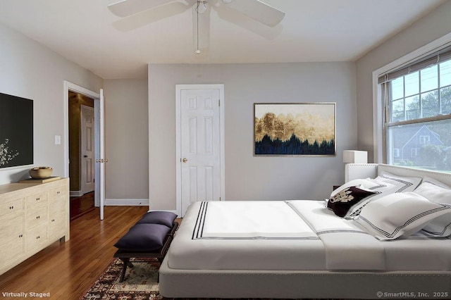 bedroom with wood finished floors, a ceiling fan, and baseboards