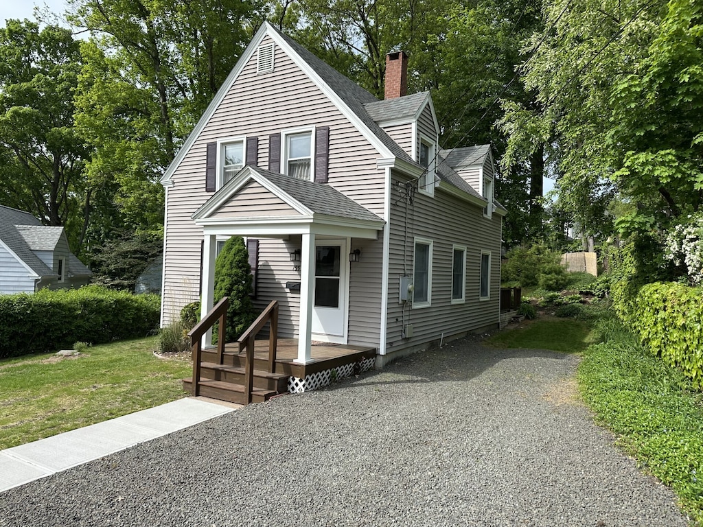 155 High St, Manchester, CT 06040 - view of front of property with a chimney, a shingled roof, a front lawn, and central AC unit