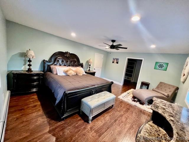 bedroom featuring recessed lighting, wood finished floors, a ceiling fan, a baseboard radiator, and baseboards