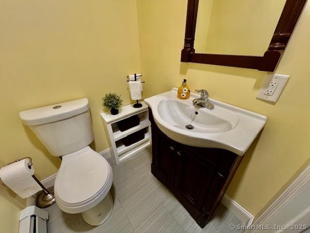 half bathroom with toilet and vanity