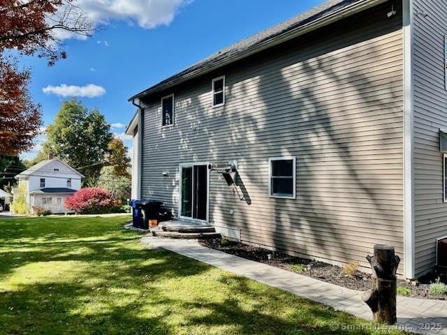 back of property featuring a yard