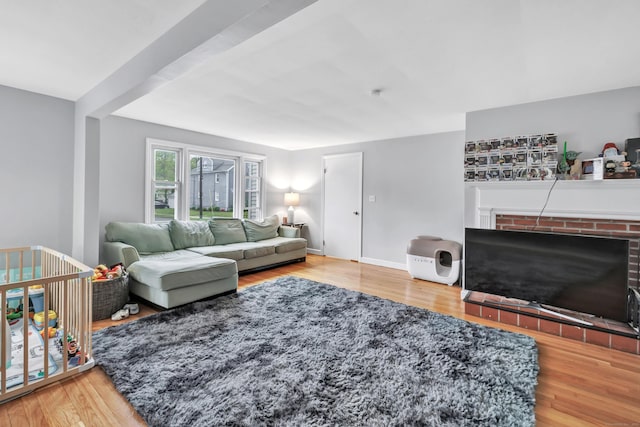 592 Courtland Ave, Bridgeport, CT 06605 - living room with wood finished floors, a fireplace, and baseboards
