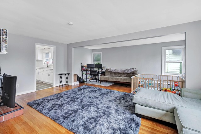 592 Courtland Ave, Bridgeport, CT 06605 - living room with wood finished floors, an office area, and baseboards