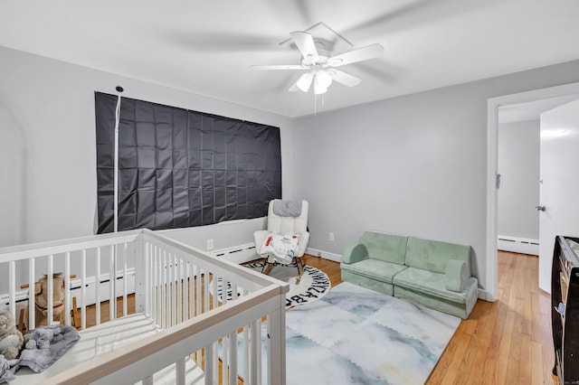 592 Courtland Ave, Bridgeport, CT 06605 - bedroom featuring baseboard heating, wood finished floors, and ceiling fan