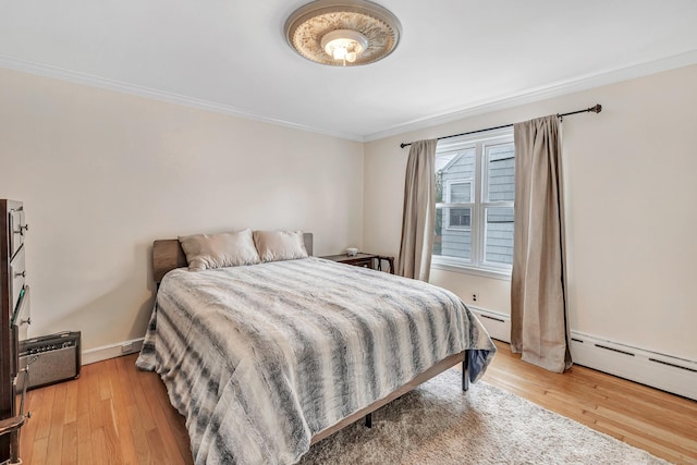 592 Courtland Ave, Bridgeport, CT 06605 - bedroom with ornamental molding, a baseboard heating unit, and light wood-style floors