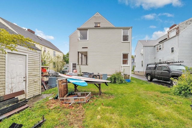 592 Courtland Ave, Bridgeport, CT 06605 - rear view of house with a lawn
