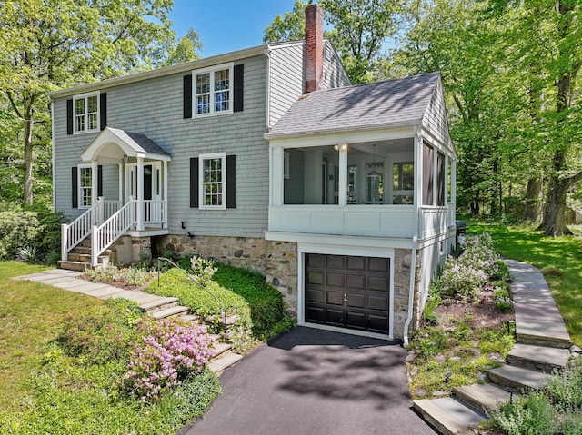 24 Richards Ln, Norwalk, CT 06851 - colonial inspired home featuring a chimney, an attached garage, a shingled roof, driveway, and a sunroom