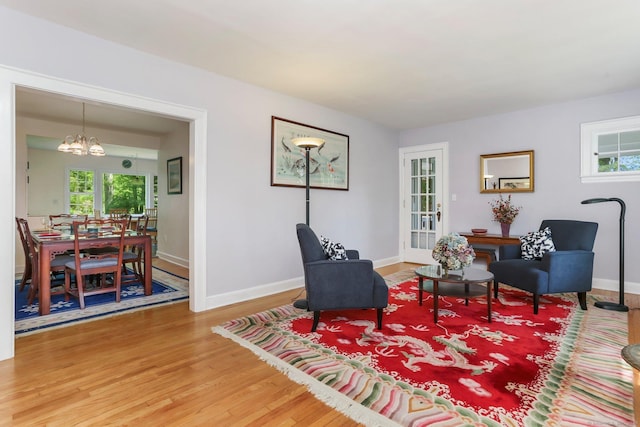 24 Richards Ln, Norwalk, CT 06851 - living area featuring a chandelier, wood finished floors, and baseboards