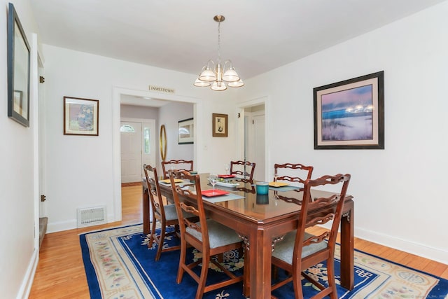 24 Richards Ln, Norwalk, CT 06851 - dining space with a chandelier, light wood finished floors, and baseboards
