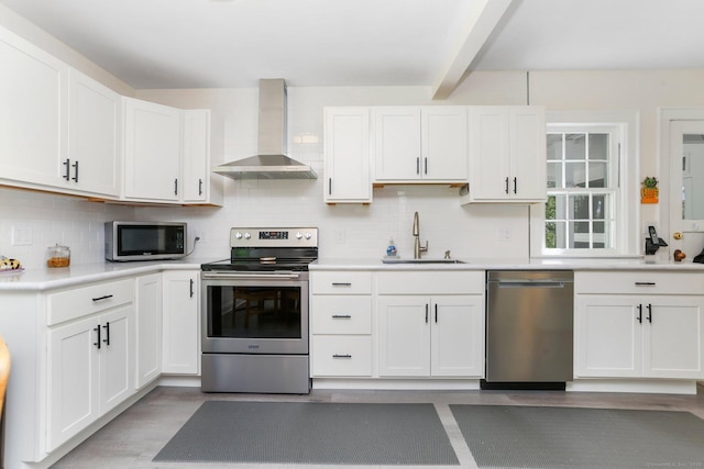 24 Richards Ln, Norwalk, CT 06851 - kitchen with appliances with stainless steel finishes, a sink, wall chimney range hood, light countertops, and white cabinetry