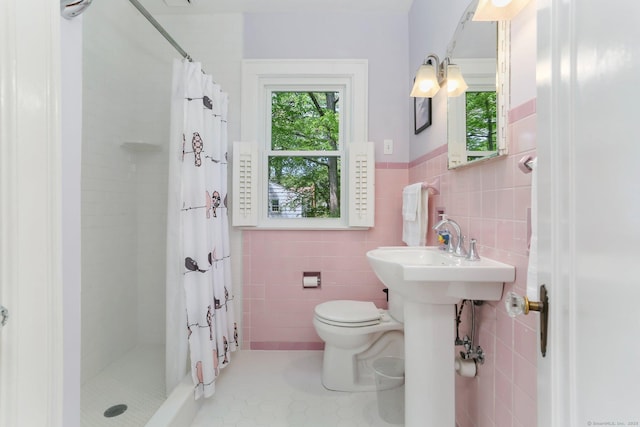 24 Richards Ln, Norwalk, CT 06851 - full bath with tile walls, a stall shower, toilet, a wainscoted wall, and tile patterned floors