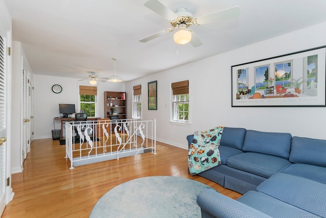 24 Richards Ln, Norwalk, CT 06851 - living room featuring a ceiling fan, wood finished floors, baseboards, and healthy amount of natural light