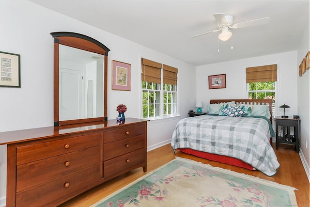 24 Richards Ln, Norwalk, CT 06851 - bedroom with light wood finished floors, multiple windows, and baseboards