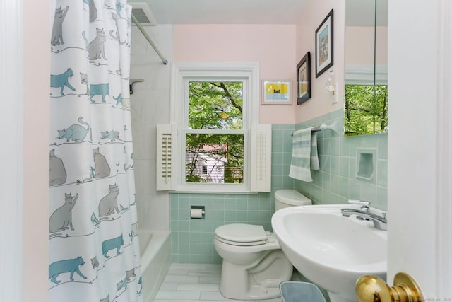 24 Richards Ln, Norwalk, CT 06851 - bathroom featuring tile walls, a sink, toilet, tile patterned flooring, and shower / bath combo with shower curtain